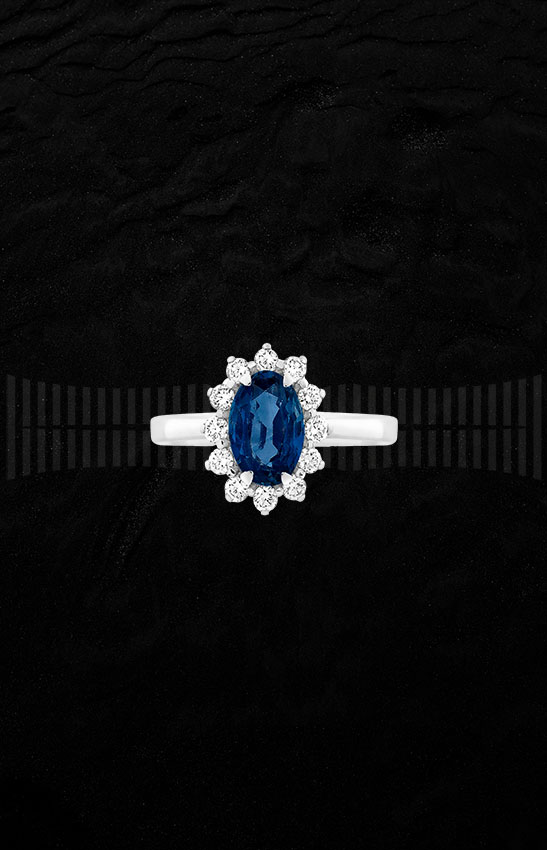 Anillo de oro blanco de 1ª Ley con zafiro central y diamantes talla brillante