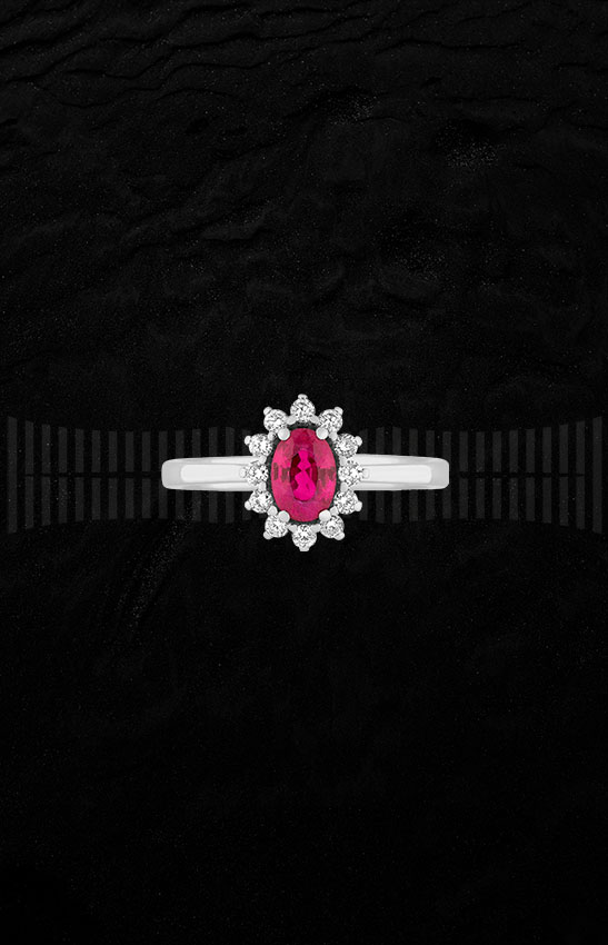 Anillo de oro blanco de 1ª Ley con rubí central y diamantes talla brillante